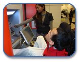 client with aac device at bank machine